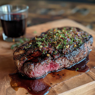 Herb-Crusted Ribeye with Red Wine Reduction